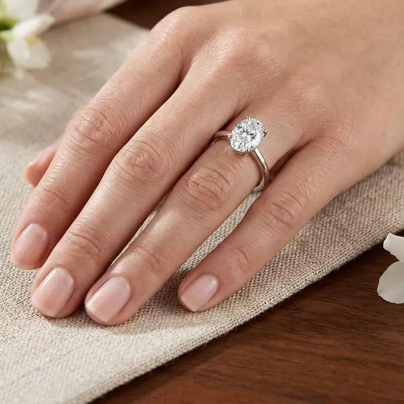 Oval cut moissanite solitaire ring worn on hand