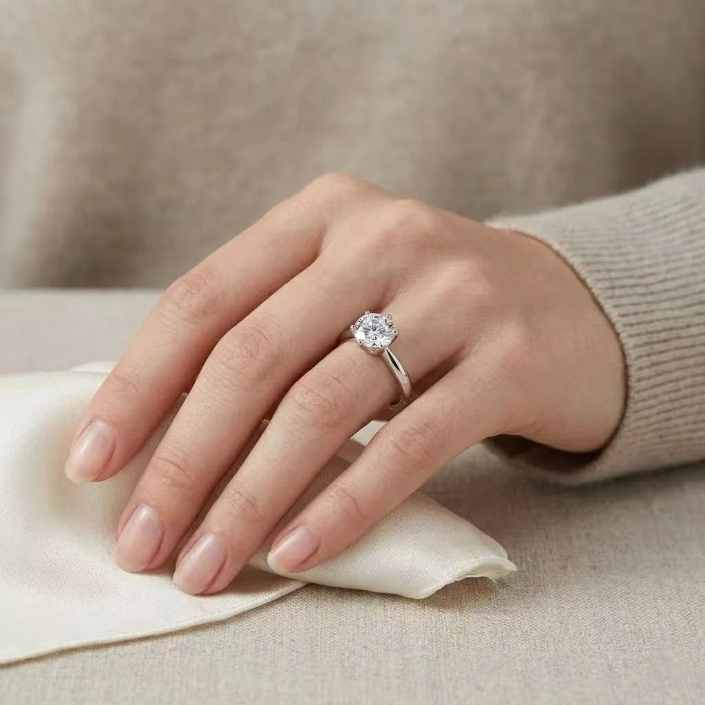 Classic round cut moissanite engagement ring on model hand