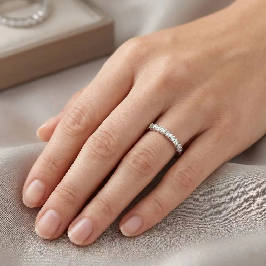 Stackable moissanite wedding band worn on hand